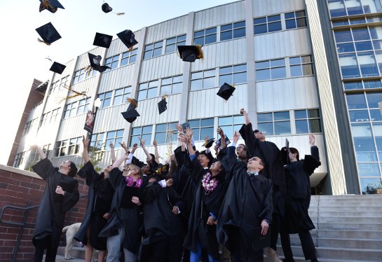 Graduates throwing caps