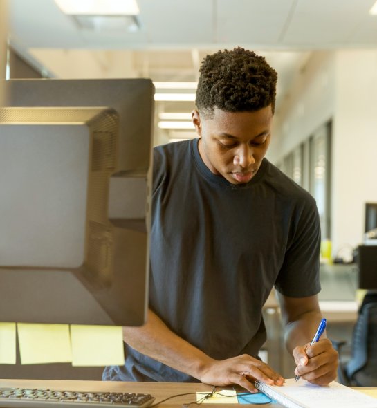 student standing and writing