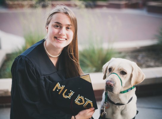 smiling grad with dog