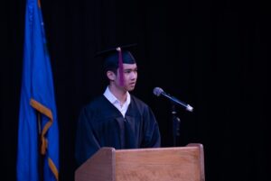 Grad speaking at podium