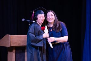 Graduate posing with instructor